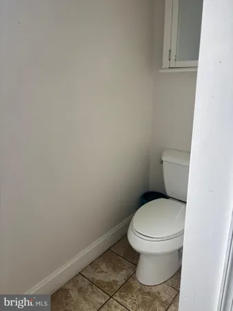 a white toilet sitting next to a white cabinet