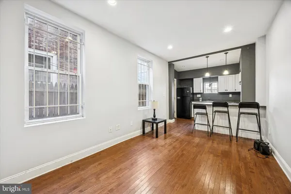 a view of a kitchen with dining room and wooden floor