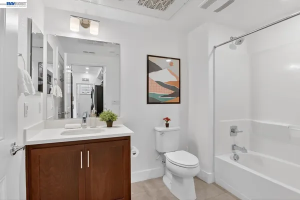 a bathroom with a sink vanity mirror and toilet