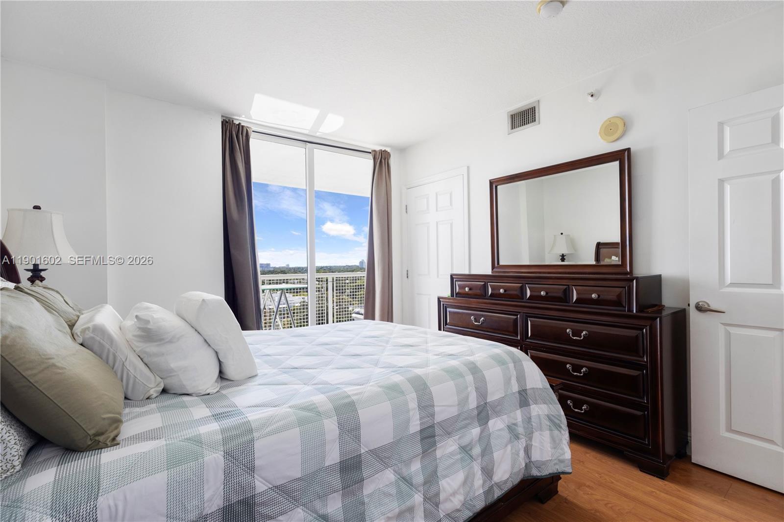 900 Southwest 8th Street, Unit 1009 Miami, FL 33130 - Photo 21 of 30 a bedroom with a bed and a dresser