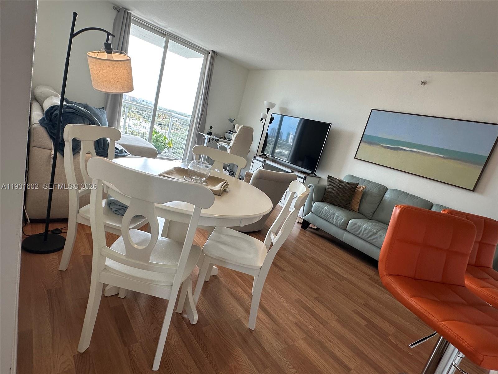 900 Southwest 8th Street, Unit 1009 Miami, FL 33130 - Photo 3 of 30 a living room with furniture and a mirror