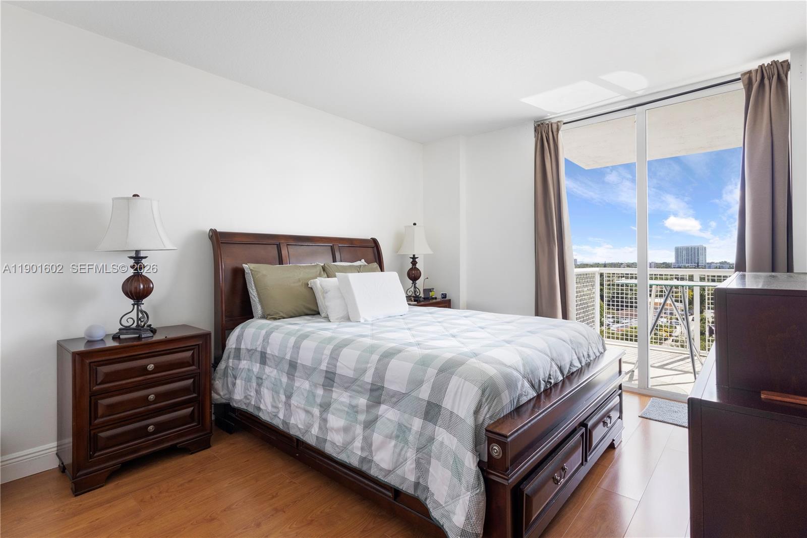 900 Southwest 8th Street, Unit 1009 Miami, FL 33130 - Photo 5 of 30 a bedroom with a bed window and dresser