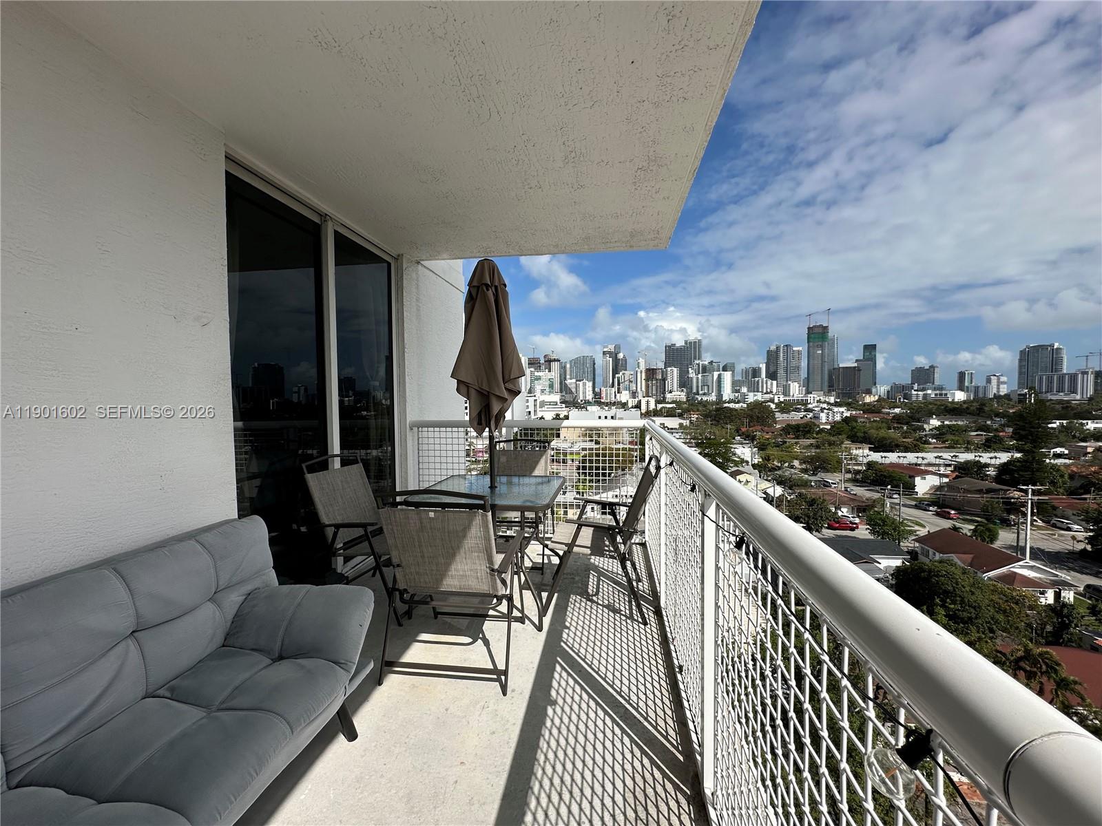 900 Southwest 8th Street, Unit 1009 Miami, FL 33130 - Photo 9 of 30 a view of a balcony with furniture and city view