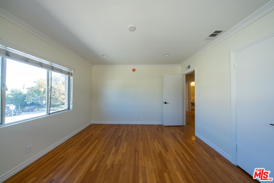 9205 Alcott Street, Unit 4 Los Angeles, CA 90035 - Photo 3 of 7 a view of a room with wooden floor and window