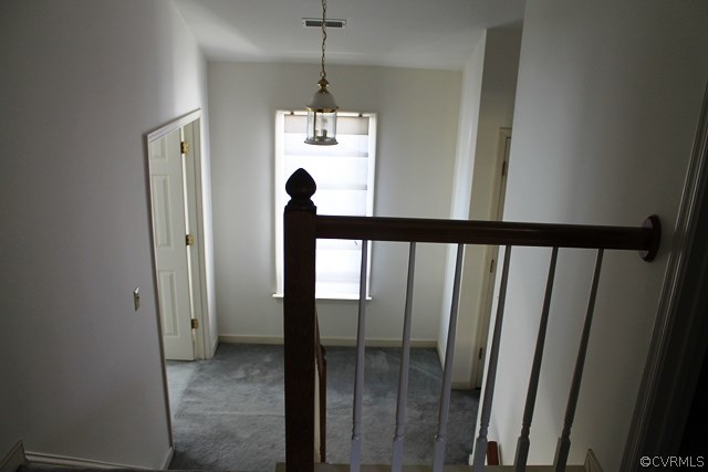 5405 Chestnut Bluff Road Midlothian, VA 23112 - Photo 16 of 19 a view of a hallway with wooden floor and chandelier