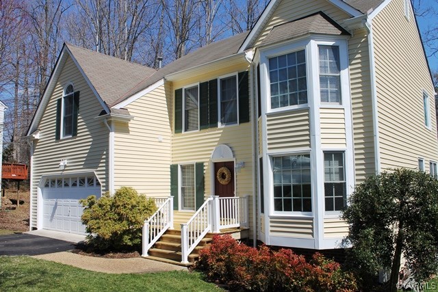 5405 Chestnut Bluff Road Midlothian, VA 23112 - Photo 19 of 19 a house with potted plants in front of it