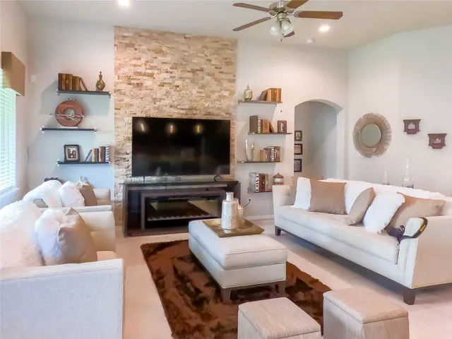 a living room with furniture and a fireplace
