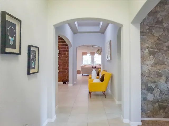 a bathroom with a toilet and a chair