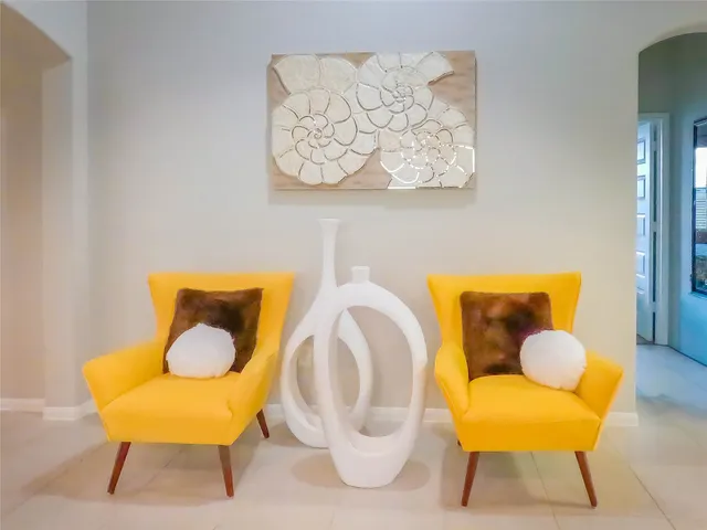 a living room with furniture and a mirror