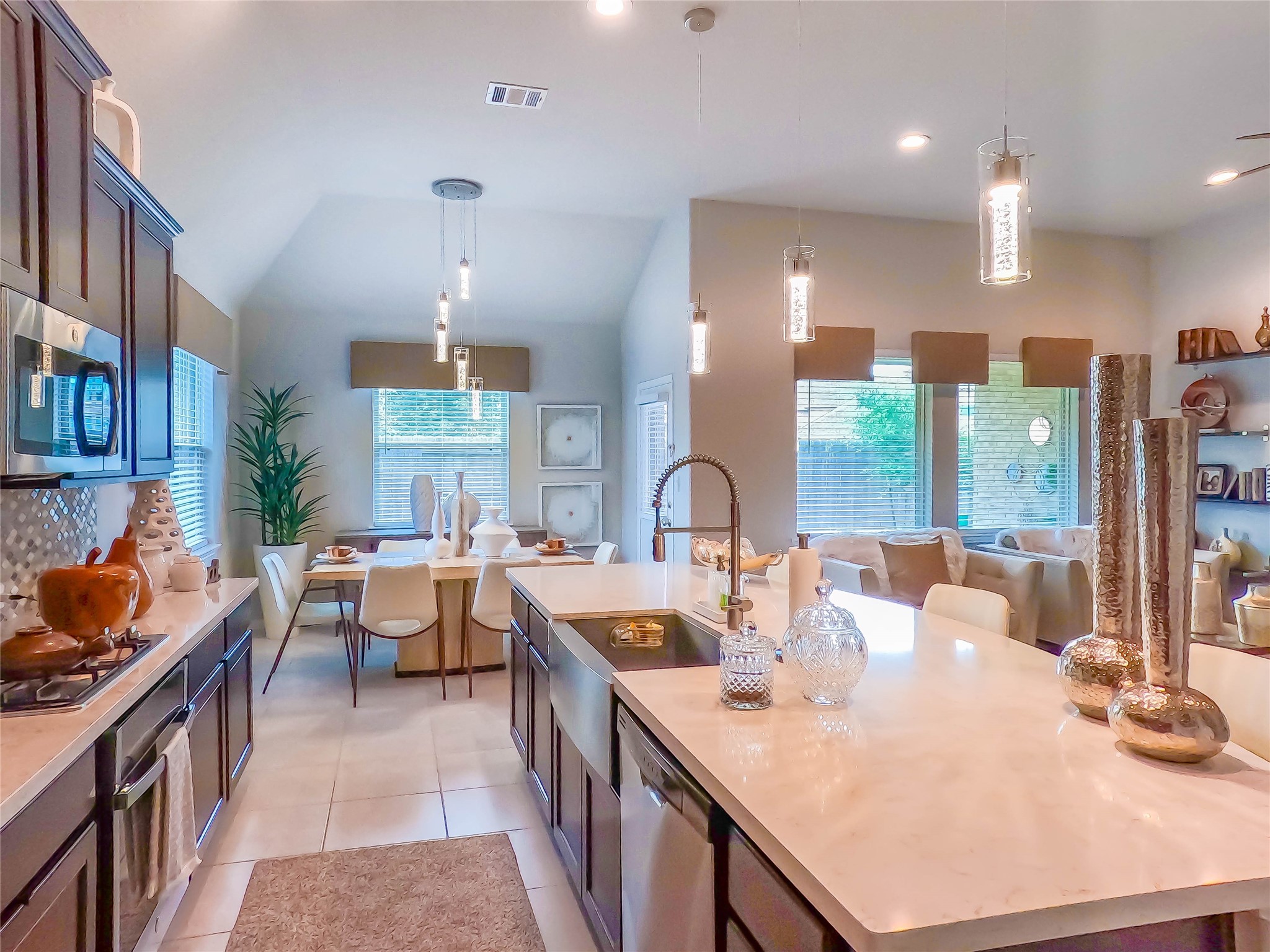 4306 Sandhill Terrace Lane Katy, TX 77493 - Photo 38 of 45 a large kitchen with kitchen island a stove a sink a dining table and chairs