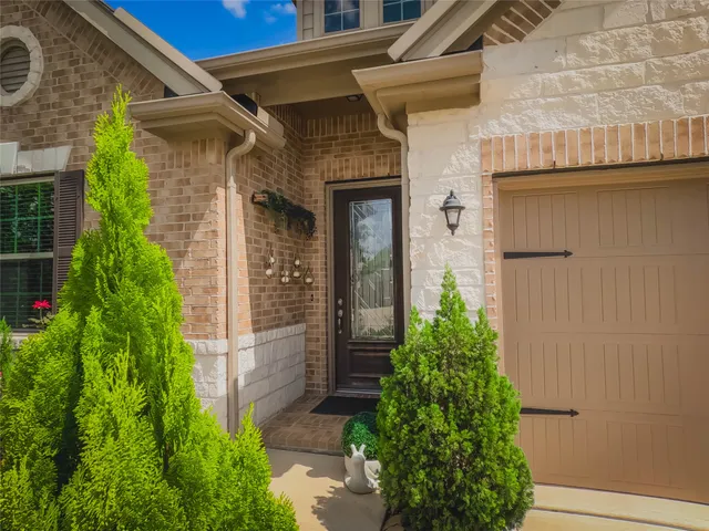a front view of a house with flowers