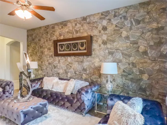 a living room with furniture and a lamp