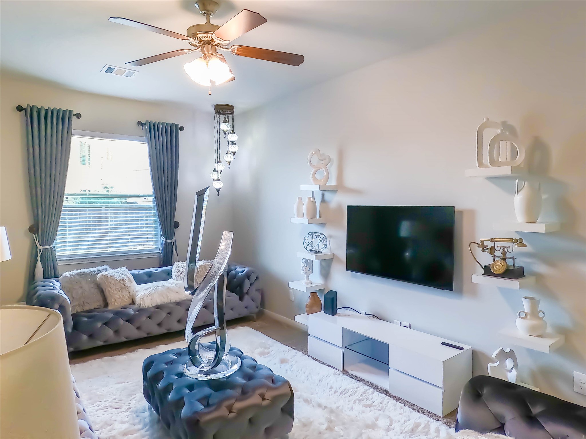 4306 Sandhill Terrace Lane Katy, TX 77493 - Photo 9 of 45 a living room with furniture a flat screen tv and a large window