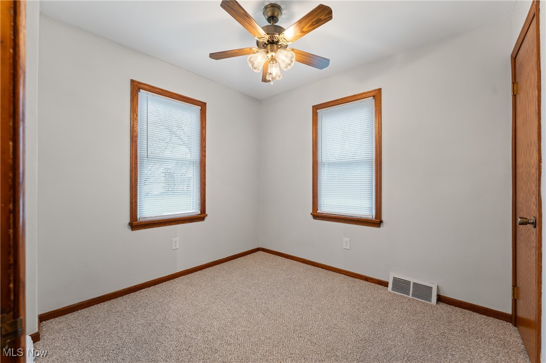 631 Killinger Road Clinton, OH 44216 - Photo 16 of 50 Carpeted dining room with ceiling fan