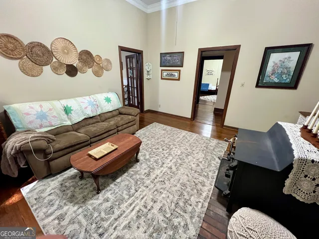 a living room with furniture and wooden floor