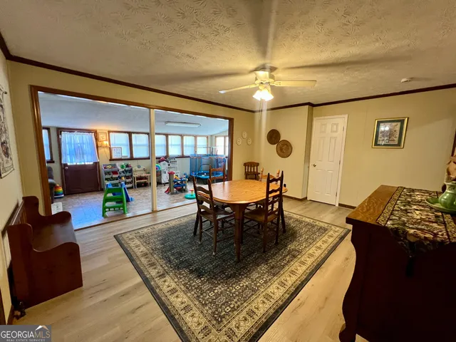 a living room with furniture and a dining table