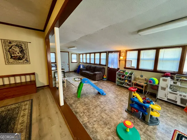 a bedroom with furniture and a wooden floor