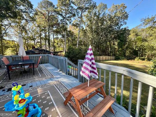 a view of deck with furniture and garden