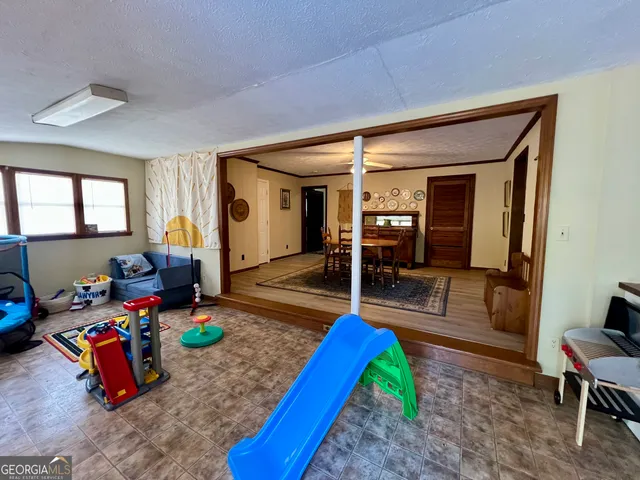 a living room with furniture a rug and white walls