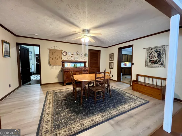 a dining room with furniture a rug and wooden floor