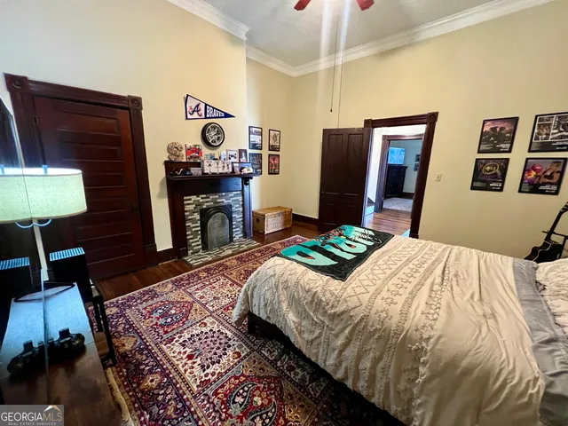 a bedroom with a bed and a lamp on dresser