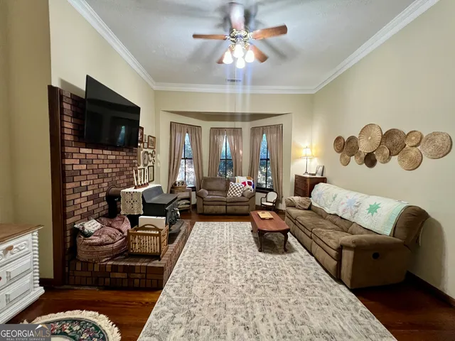 a living room with fireplace furniture and a flat screen tv