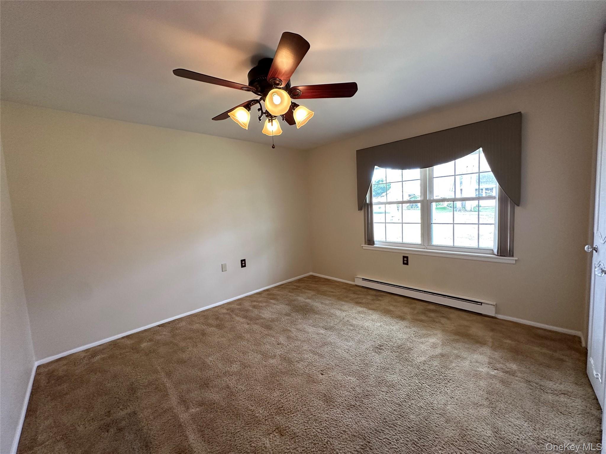 9 Guilford Court, Unit B Ridge, NY 11961 - Photo 11 of 12 a view of an empty room with a window