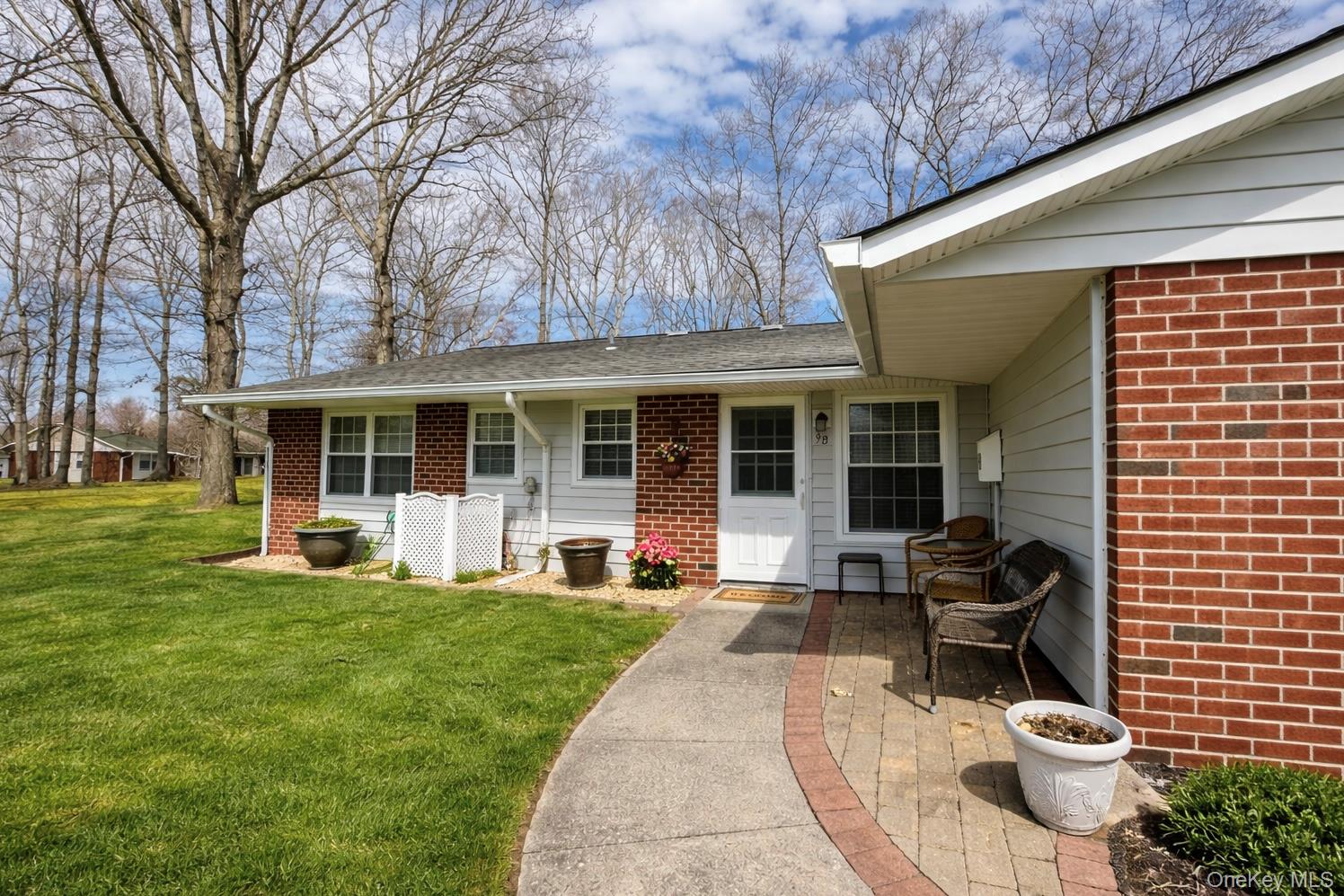9 Guilford Court, Unit B Ridge, NY 11961 - Photo 3 of 12 a house view with a sitting space and garden