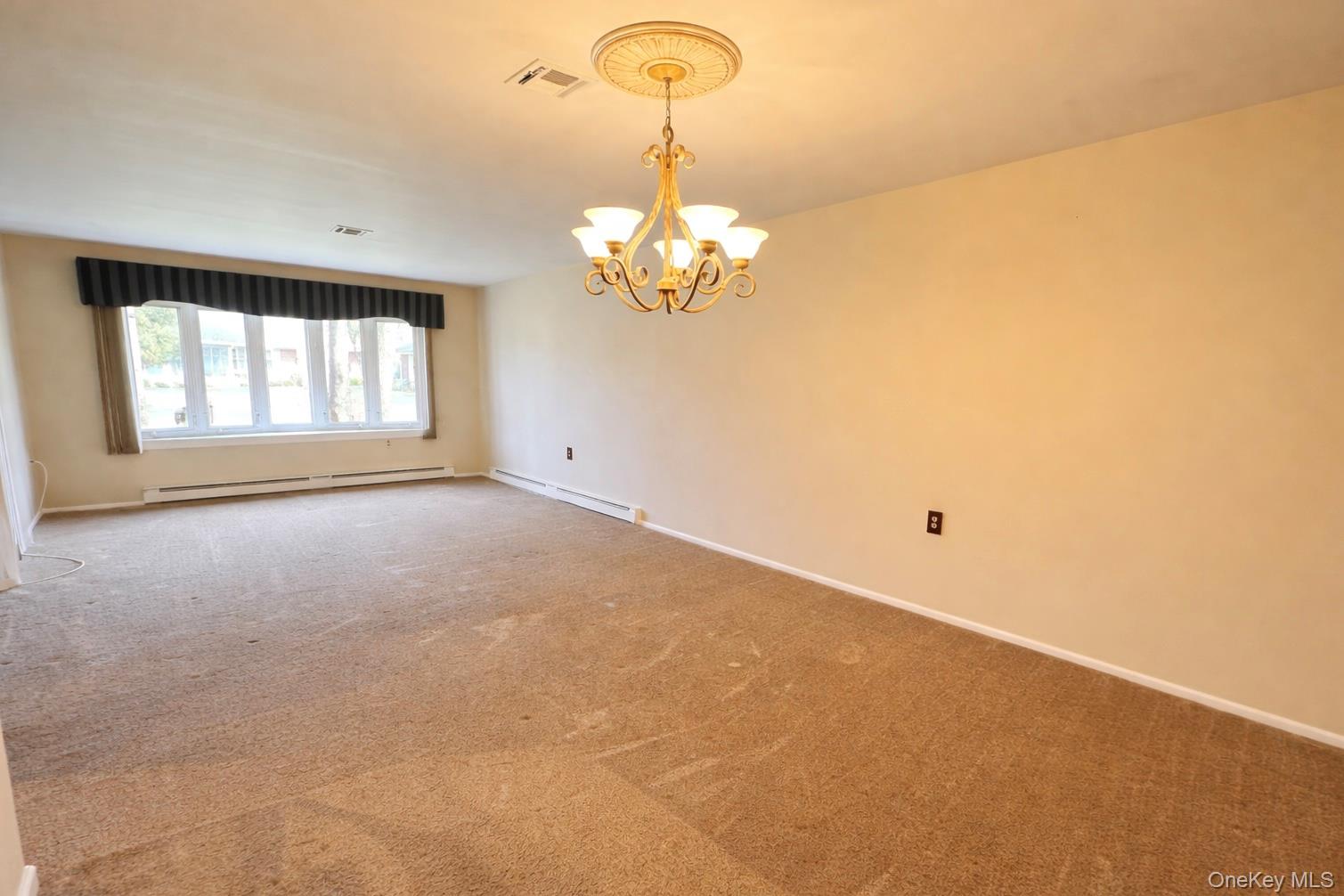 9 Guilford Court, Unit B Ridge, NY 11961 - Photo 6 of 12 a view of empty room with window