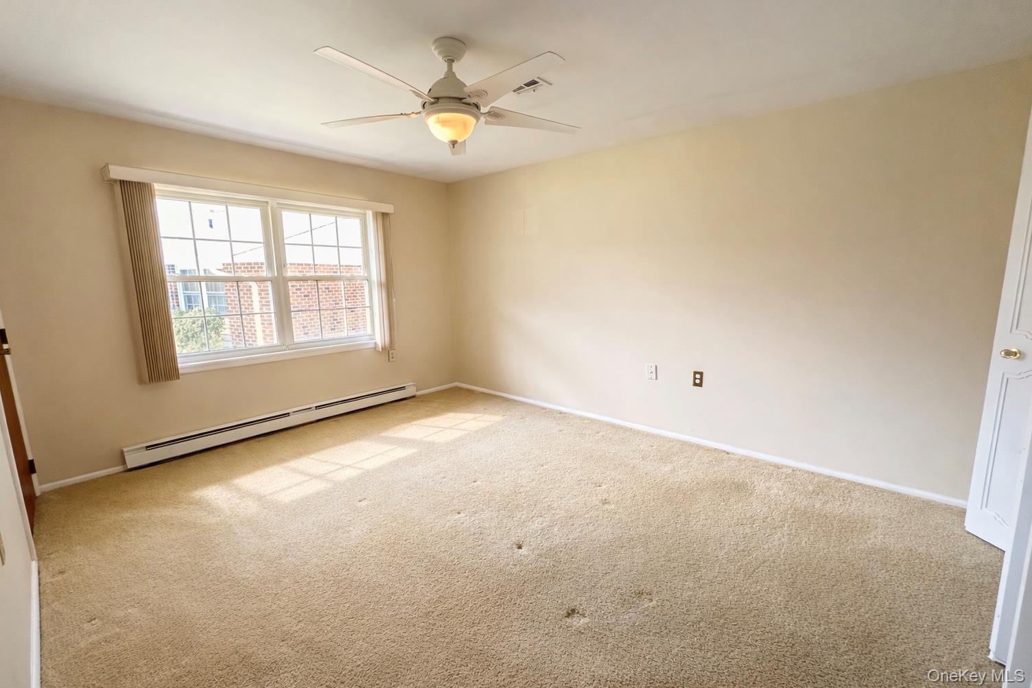 9 Guilford Court, Unit B Ridge, NY 11961 - Photo 9 of 12 an empty room with windows