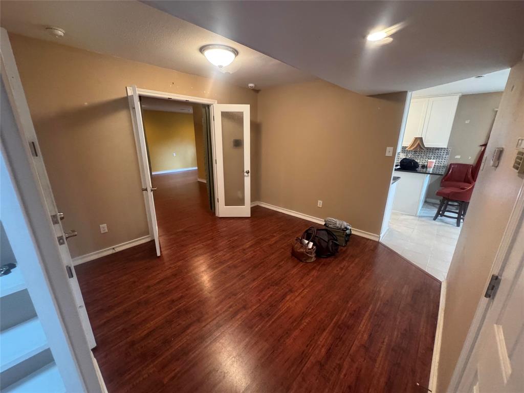 4649 Misty Ridge Drive Fort Worth, TX 76137 - Photo 20 of 25 a view of room with wooden floor and stairs