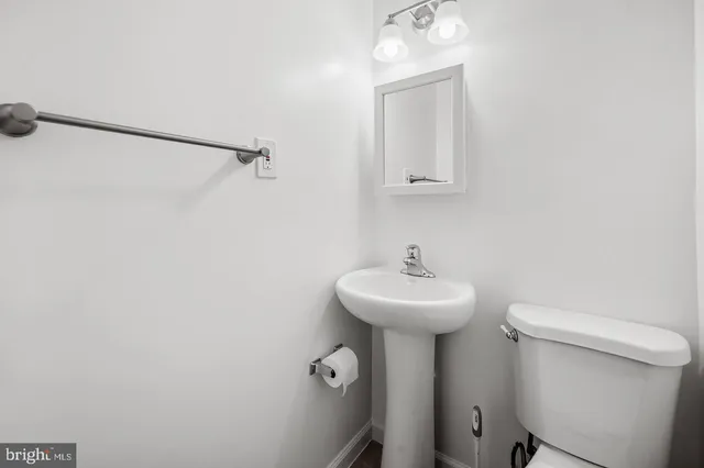 a bathroom with a sink a mirror and a toilet
