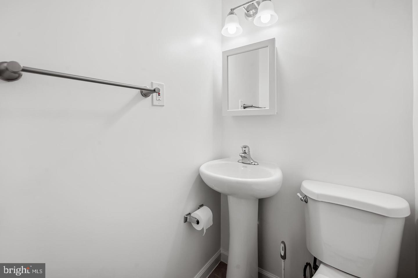 445 Pitman Place Baltimore, MD 21202 - Photo 17 of 29 a bathroom with a sink a mirror and a toilet