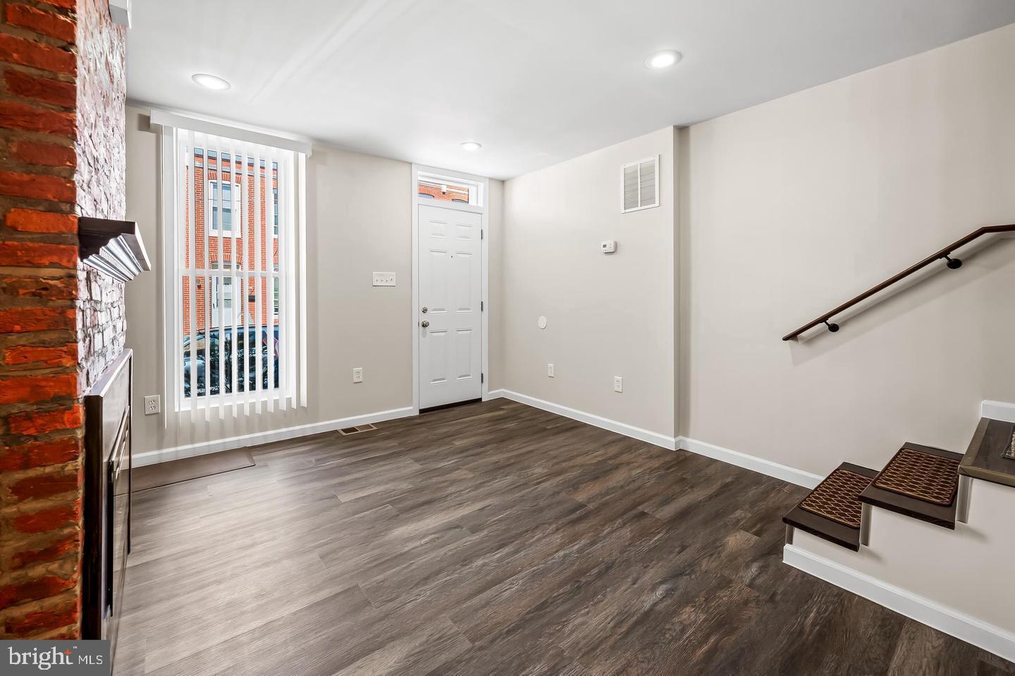 445 Pitman Place Baltimore, MD 21202 - Photo 2 of 29 a view of a livingroom with wooden floor and white walls