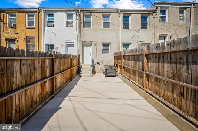 a view of a brick house with large windows