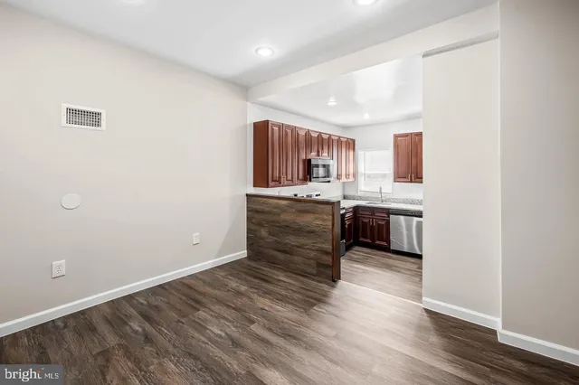 a kitchen with granite countertop a sink and cabinets