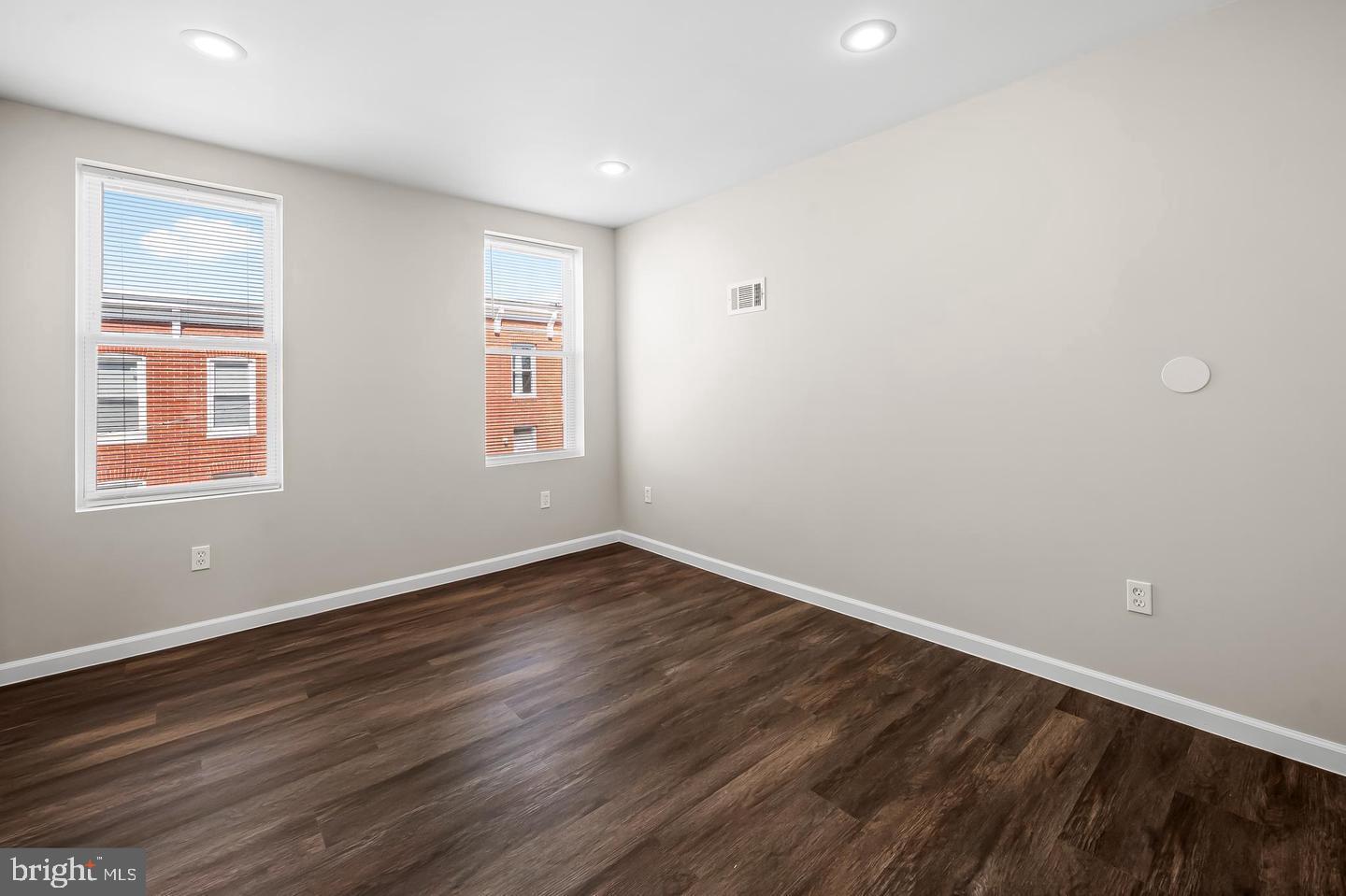 445 Pitman Place Baltimore, MD 21202 - Photo 10 of 29 a view of an empty room with wooden floor and a window