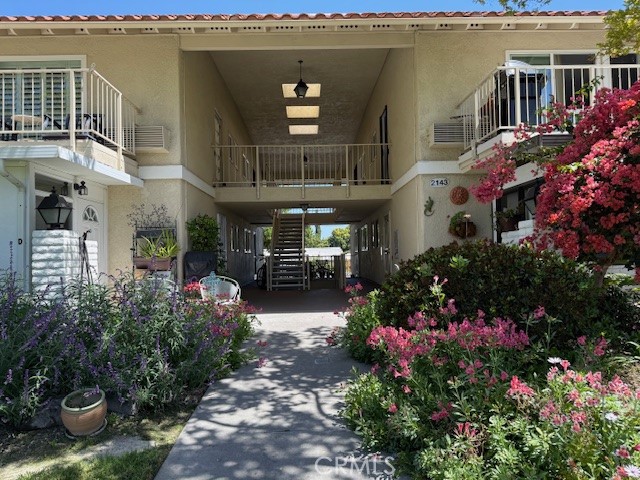 a front view of a house with a garden and pathway
