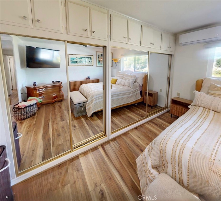 2143 Ronda Granada, Unit O Laguna Woods, CA 92637 - Photo 13 of 33 a bedroom with a bed and large windows