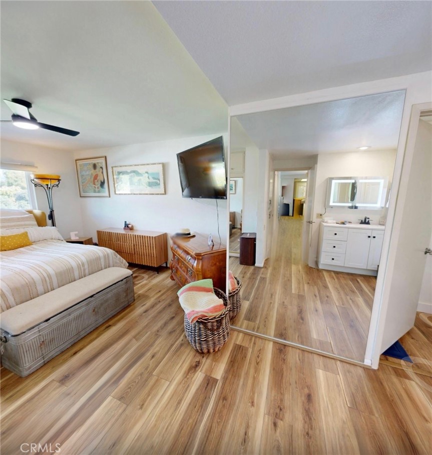 2143 Ronda Granada, Unit O Laguna Woods, CA 92637 - Photo 14 of 33 a spacious bedroom with a bed and a flat screen tv