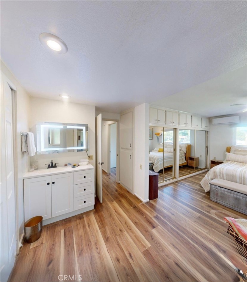 2143 Ronda Granada, Unit O Laguna Woods, CA 92637 - Photo 15 of 33 a large living room with furniture and wooden floor