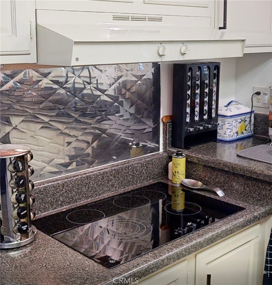 2143 Ronda Granada, Unit O Laguna Woods, CA 92637 - Photo 19 of 33 a kitchen sink with granite countertop lots of clutter
