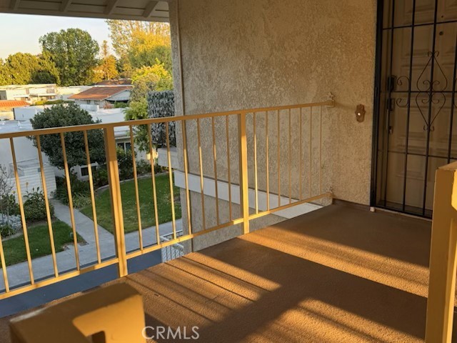 2143 Ronda Granada, Unit O Laguna Woods, CA 92637 - Photo 2 of 33 a view of a balcony with floor to ceiling window next to a yard