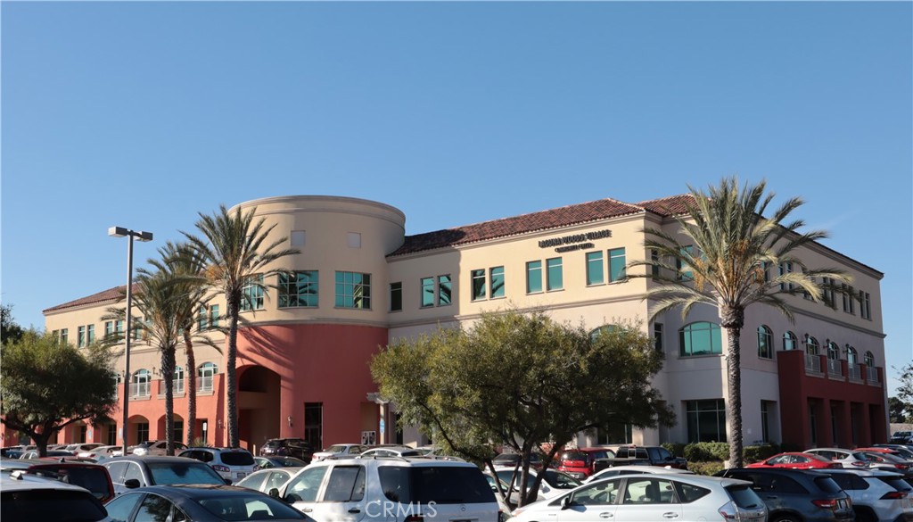 2143 Ronda Granada, Unit O Laguna Woods, CA 92637 - Photo 29 of 33 a front view of a building with lot of cars and trees