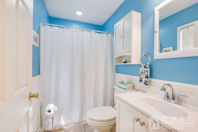 358 Old Post Road Edison, NJ 08817 - Photo 21 of 45 a bathroom with a sink a toilet and a mirror