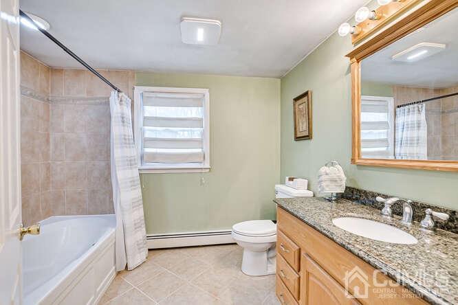 358 Old Post Road Edison, NJ 08817 - Photo 25 of 45 a bathroom with a granite countertop sink a toilet and bathtub