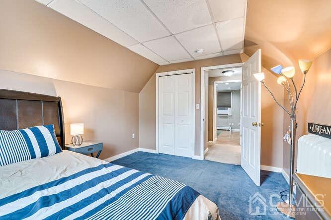 358 Old Post Road Edison, NJ 08817 - Photo 27 of 45 a spacious bedroom with a bed and wooden floor