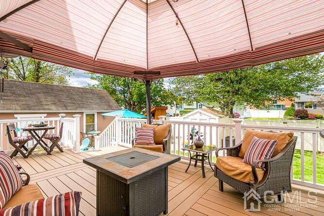 358 Old Post Road Edison, NJ 08817 - Photo 29 of 45 a view of a patio with a table and chairs under an umbrella