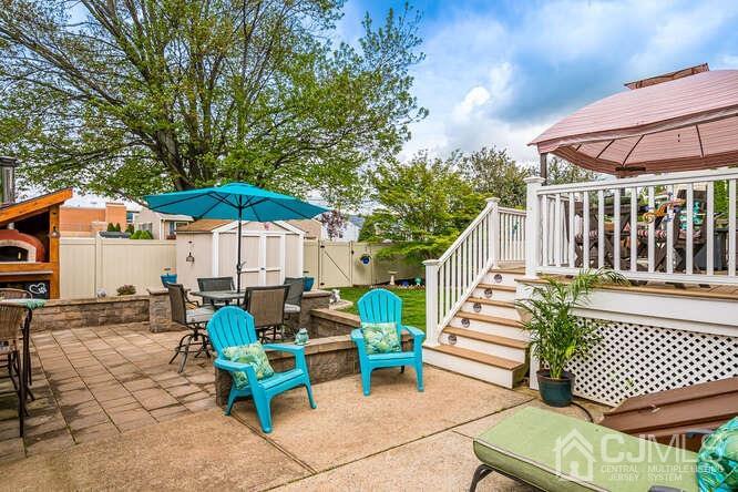 358 Old Post Road Edison, NJ 08817 - Photo 31 of 45 a view of a chairs and table in the back yard of the house