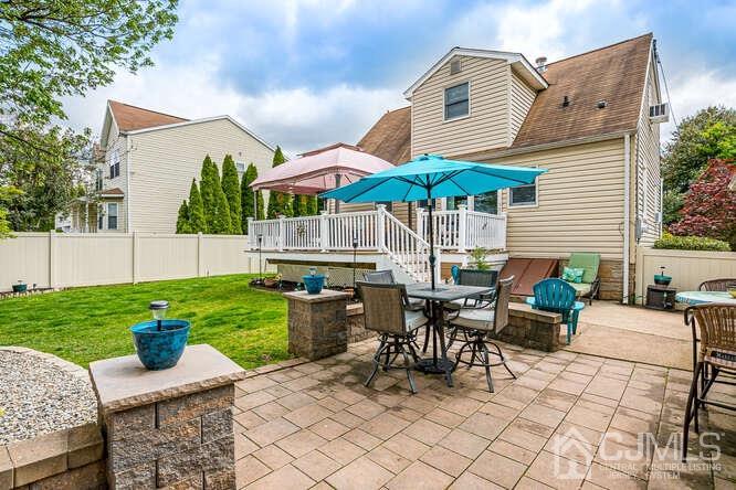 358 Old Post Road Edison, NJ 08817 - Photo 33 of 45 a view of a patio with couches table and chairs under an umbrella